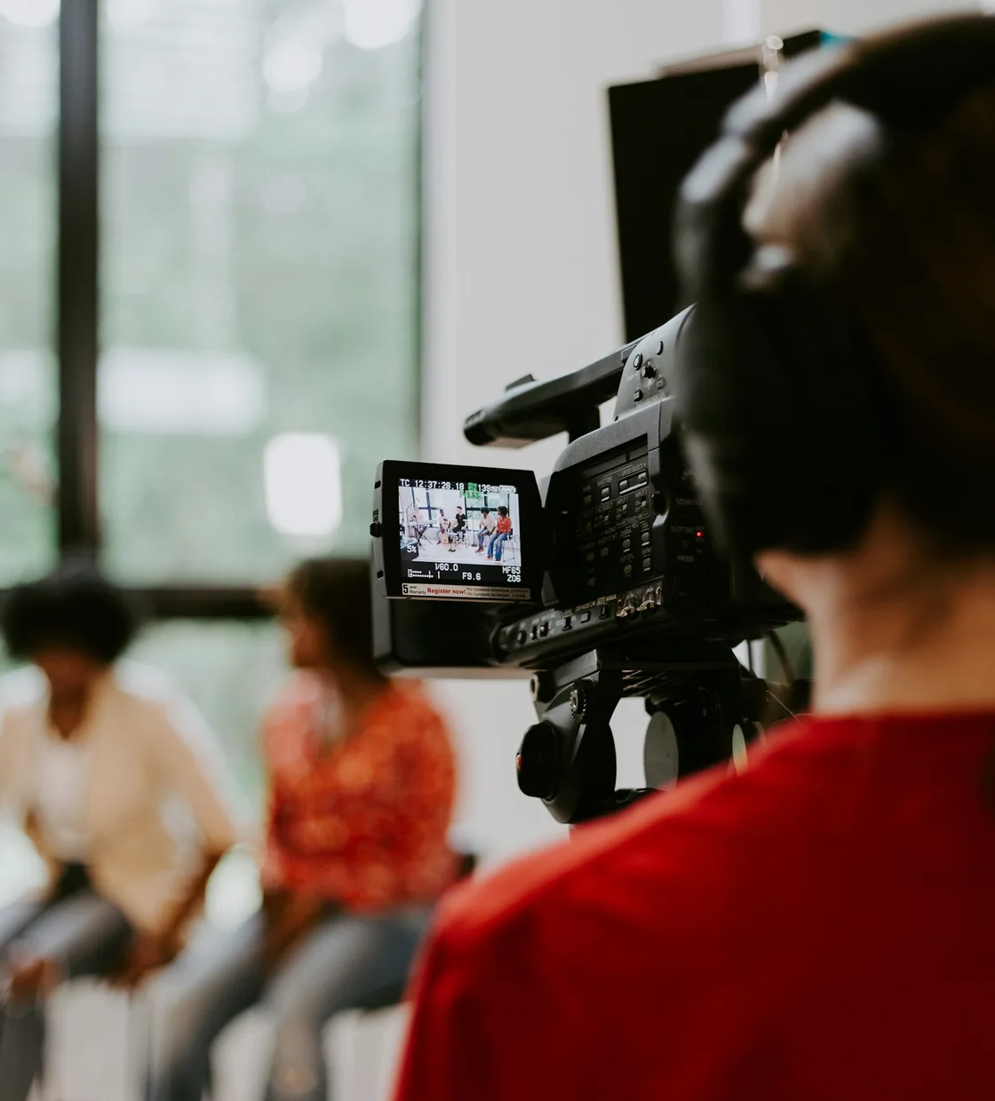 Camera operator filming at an event venue
